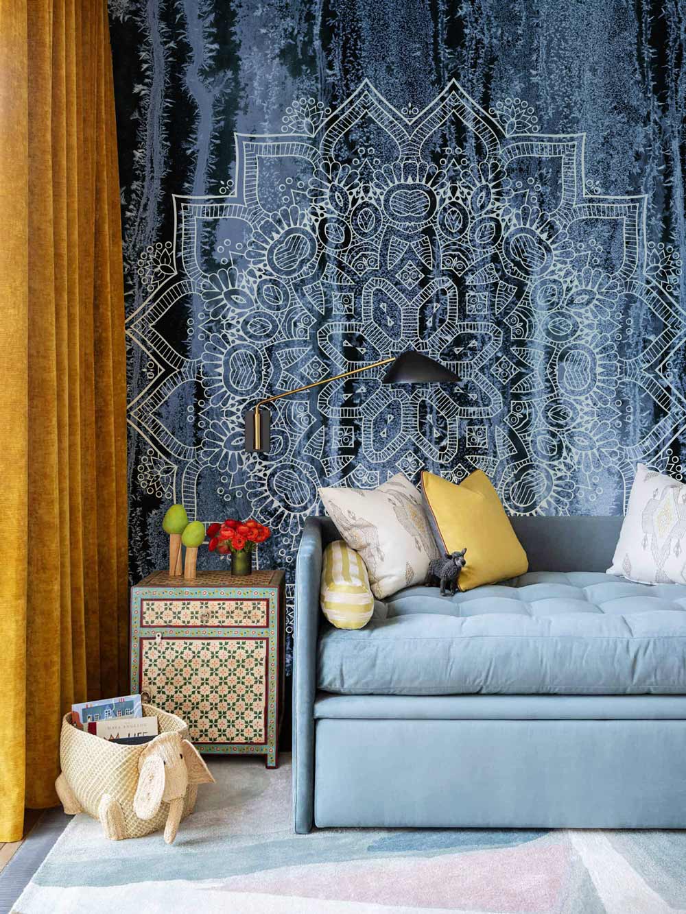 Elegant living room with Mystical Midnight Blue Mandala Wallpaper, featuring a blue sofa, mustard curtains.