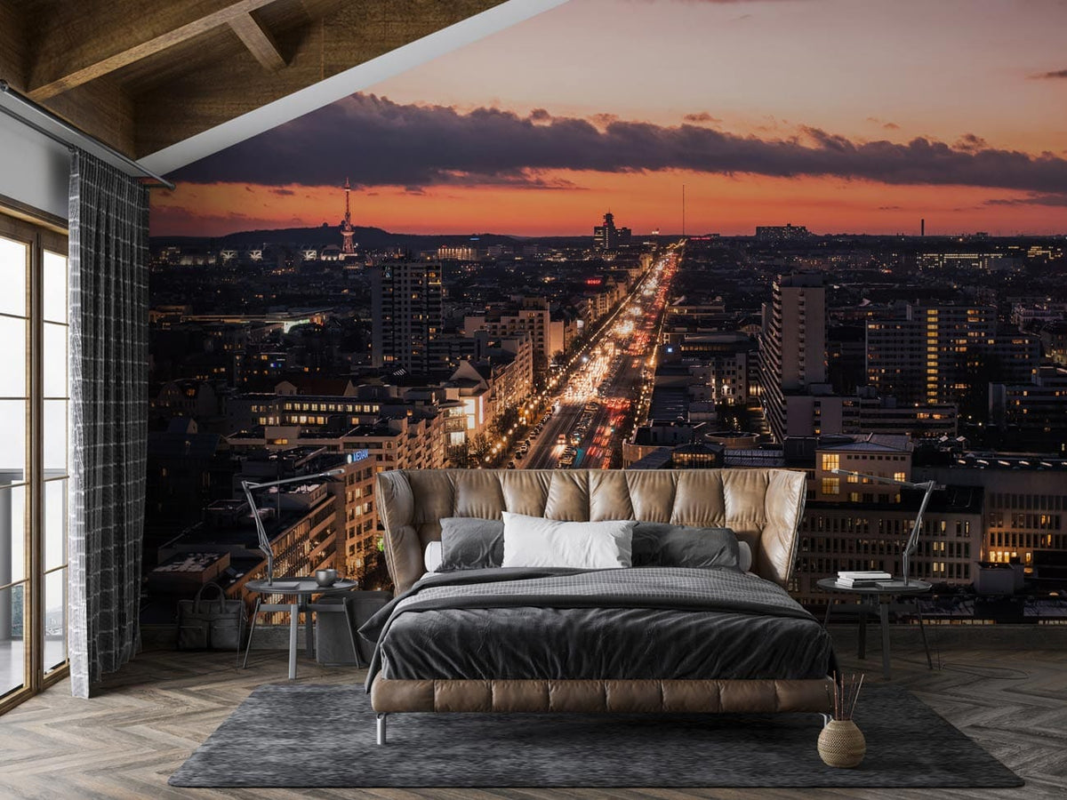 Vibrant urban sunset cityscape mural wallpaper in bedroom with grey bed, wooden ceiling, parquet flooring.