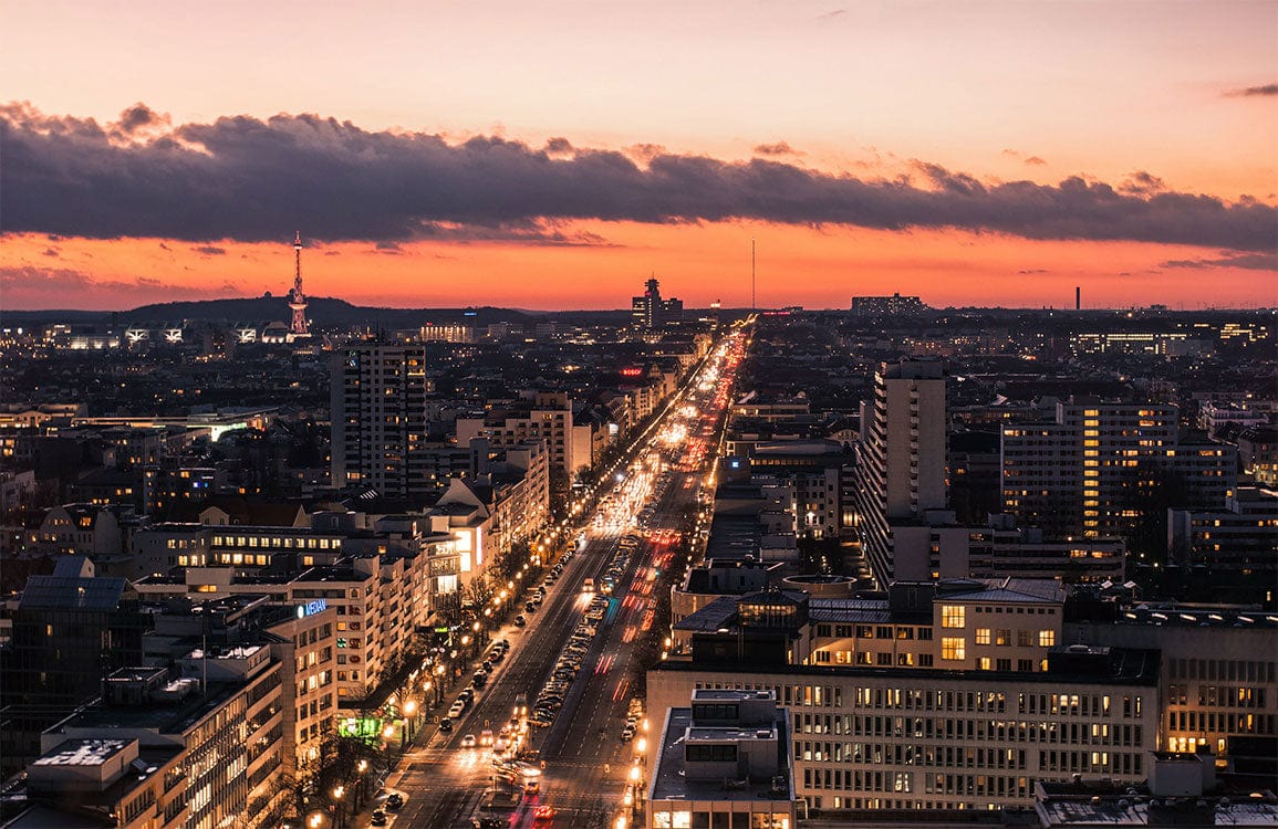 Vibrant Urban Sunset Cityscape Mural Wallpaper with Warm Tones