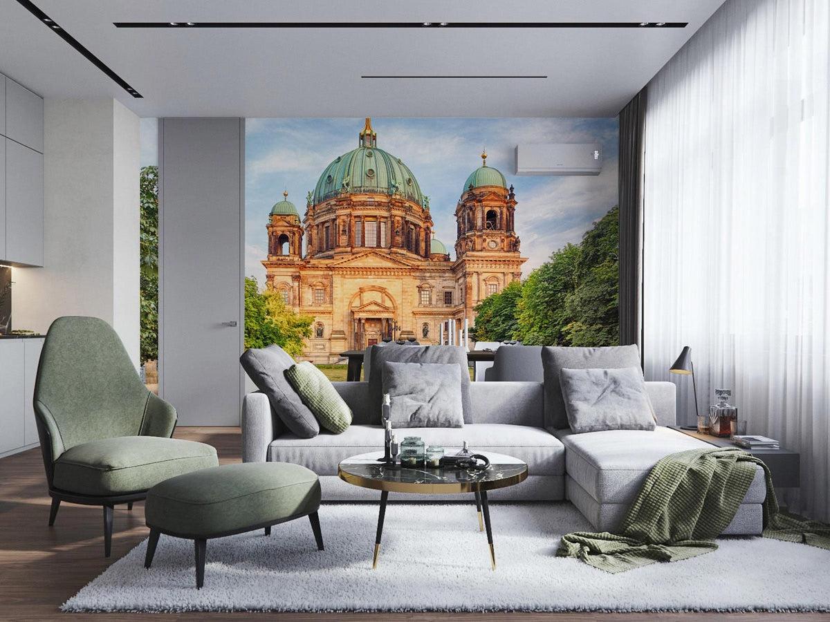 Contemporary living room with Historic European Cathedral Mural Wallpaper, grey sofa, modern armchairs, wooden flooring.