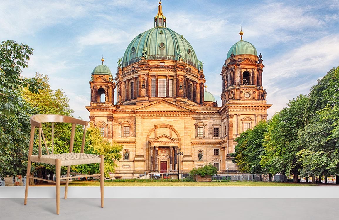 Historic European Cathedral mural wallpaper; earthy tones, light wood chair, bright setting, serene decor.