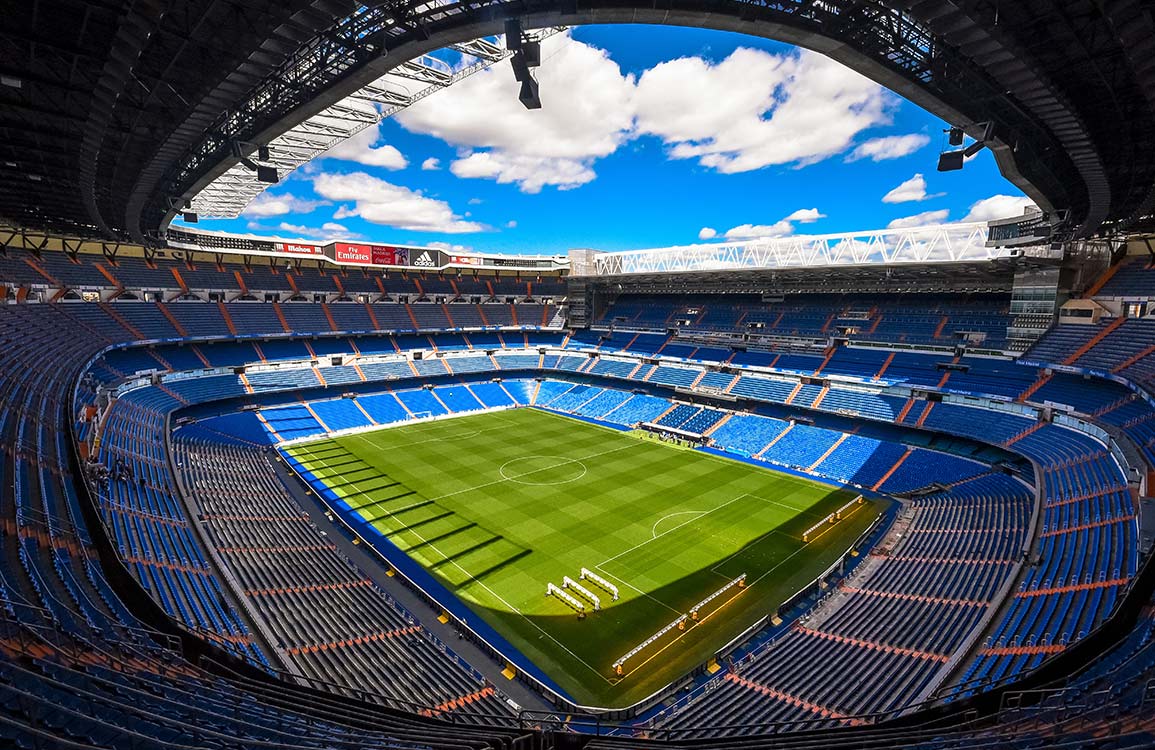 Vibrant Football Stadium Mural Wallpaper: Green Pitch, Blue Seats Design
