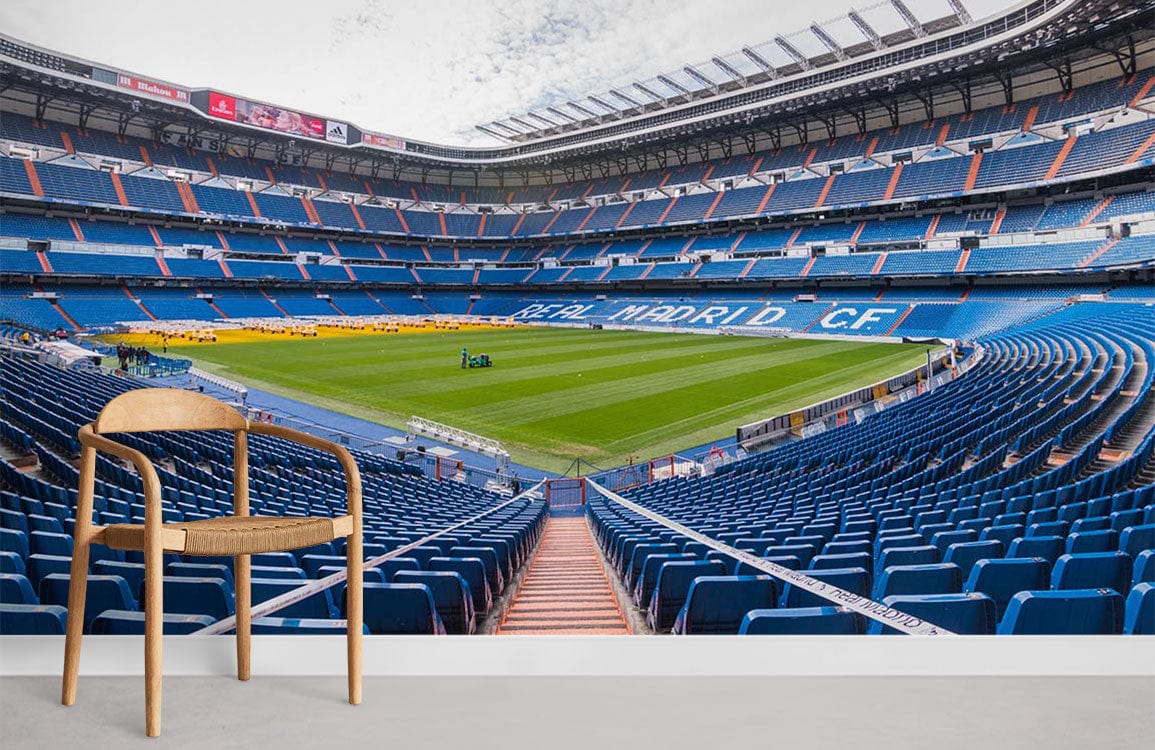 Vibrant Blue Sports Stadium Mural Wallpaper for football fans' walls, featuring wooden chair, grey floor.