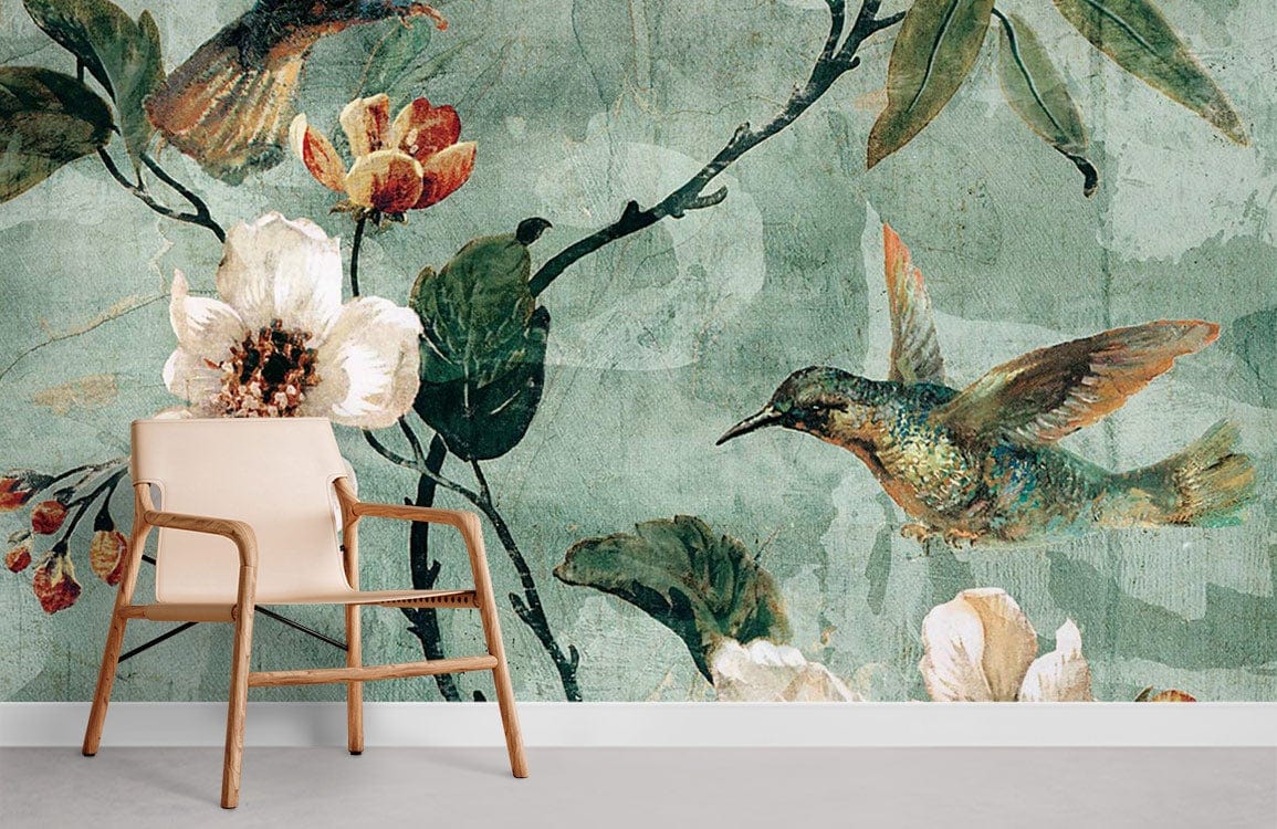 Vintage botanical mural wallpaper with hummingbird, floral design, soft green tones, modern beige chair.