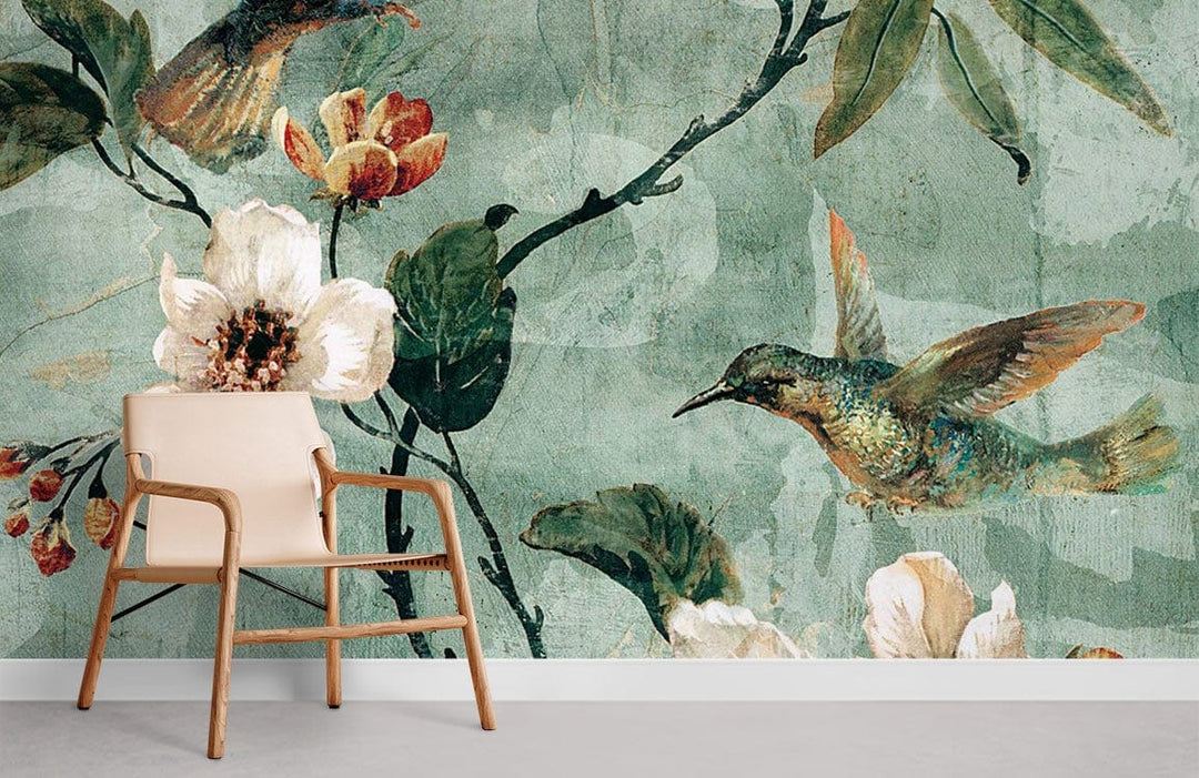 Vintage botanical mural wallpaper with hummingbird, floral design, soft green tones, modern beige chair.