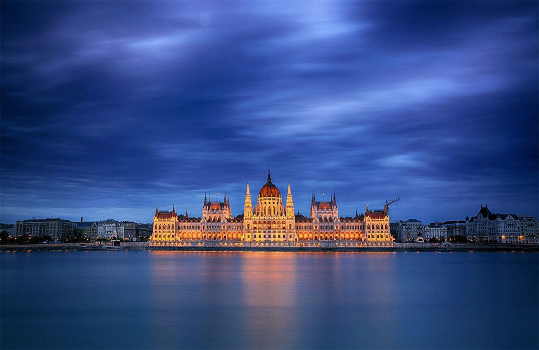 Majestic Nightscape Mural Wallpaper: Illuminated Landmark Under Dramatic Blue Skies
