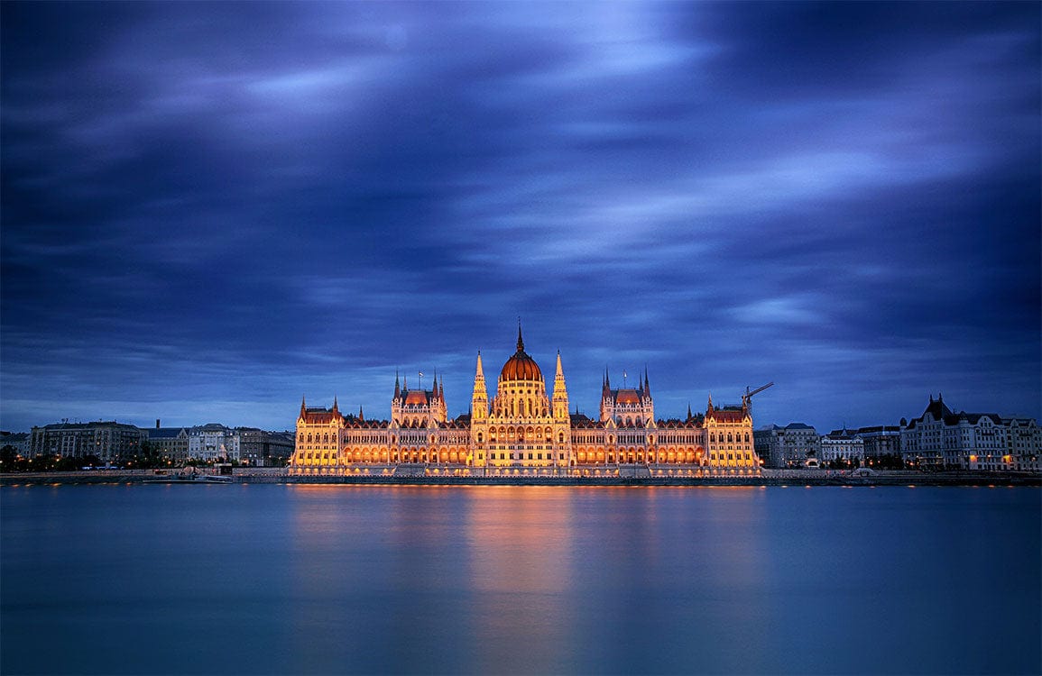 Majestic Nightscape Mural Wallpaper: Illuminated Landmark Under Dramatic Blue Skies