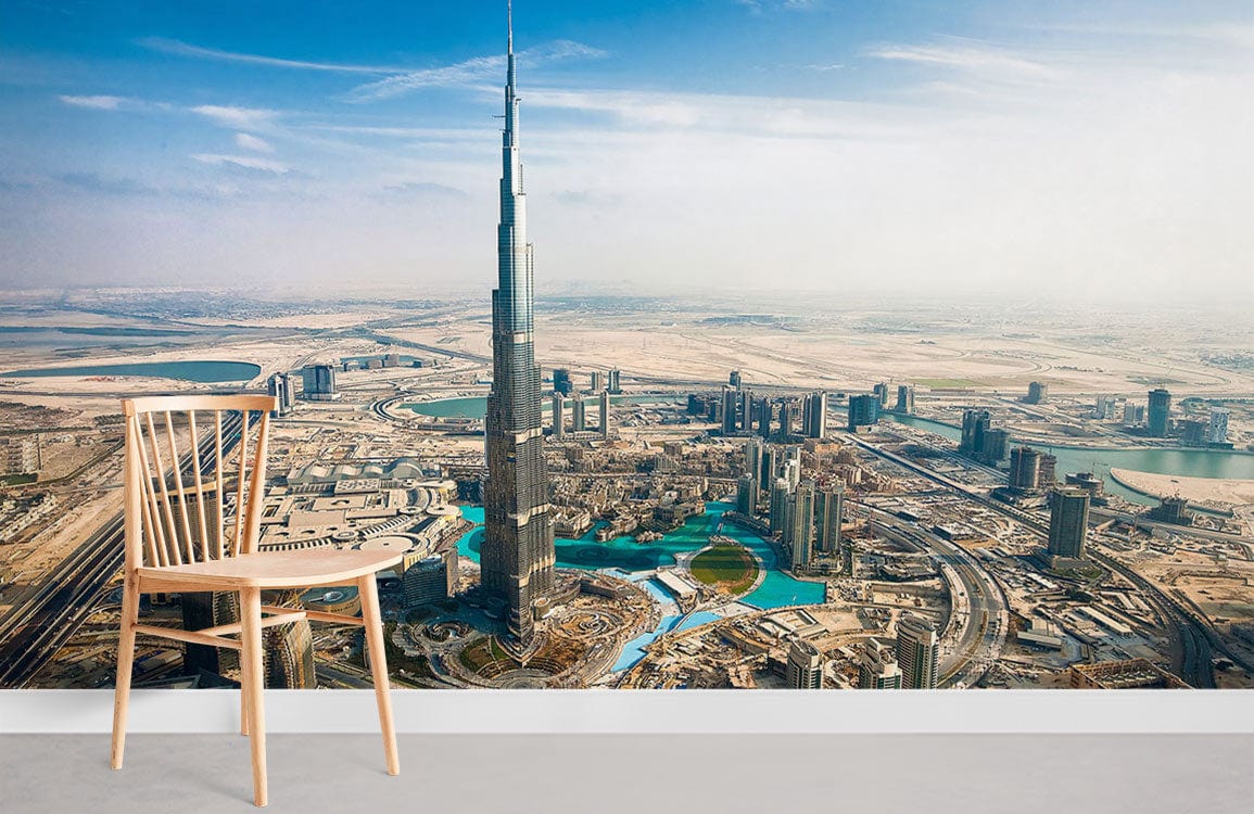 Dubai Skyline Mural Wallpaper, iconic cityscape, vibrant desert tones, wooden chair, grey flooring.