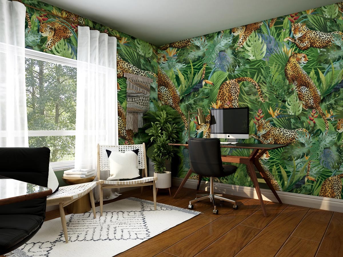 Tropical wallpaper in home office with leopards, greenery, wooden flooring, and white chairs.