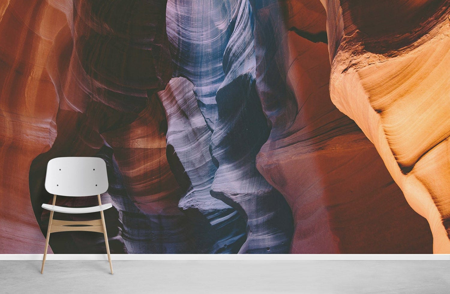 Rustic Canyon Serenity Mural Wallpaper in earthy colours, flowing patterns, modern chair, grey flooring.
