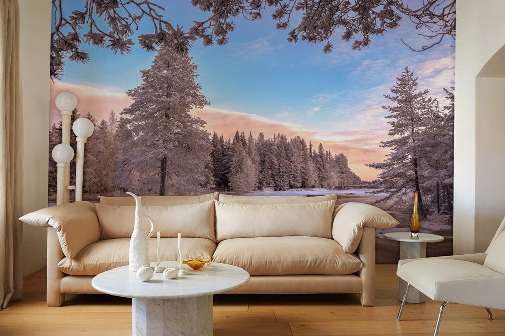 Enchanting Winter Wonderland Snowy Forest Mural Wallpaper with beige sofa, marble tables, and wooden flooring.