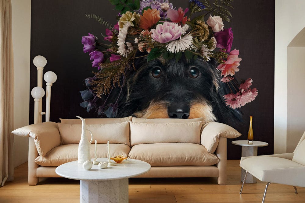 Black rustic mural featuring whimsical canine with floral crown, beige sofa, round marble coffee table.
