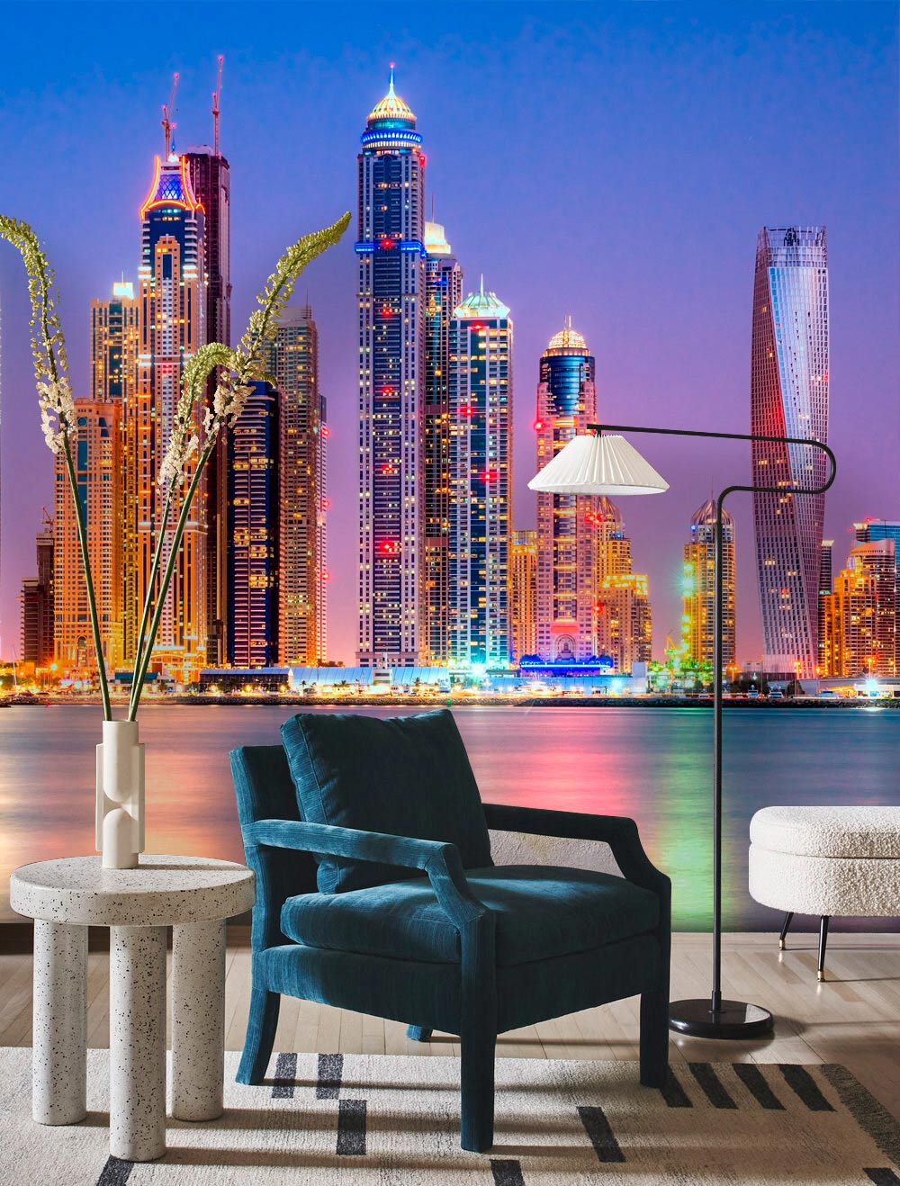 Vibrant evening skyline mural wallpaper with illuminated skyscrapers, blue velvet chair, modern round table.