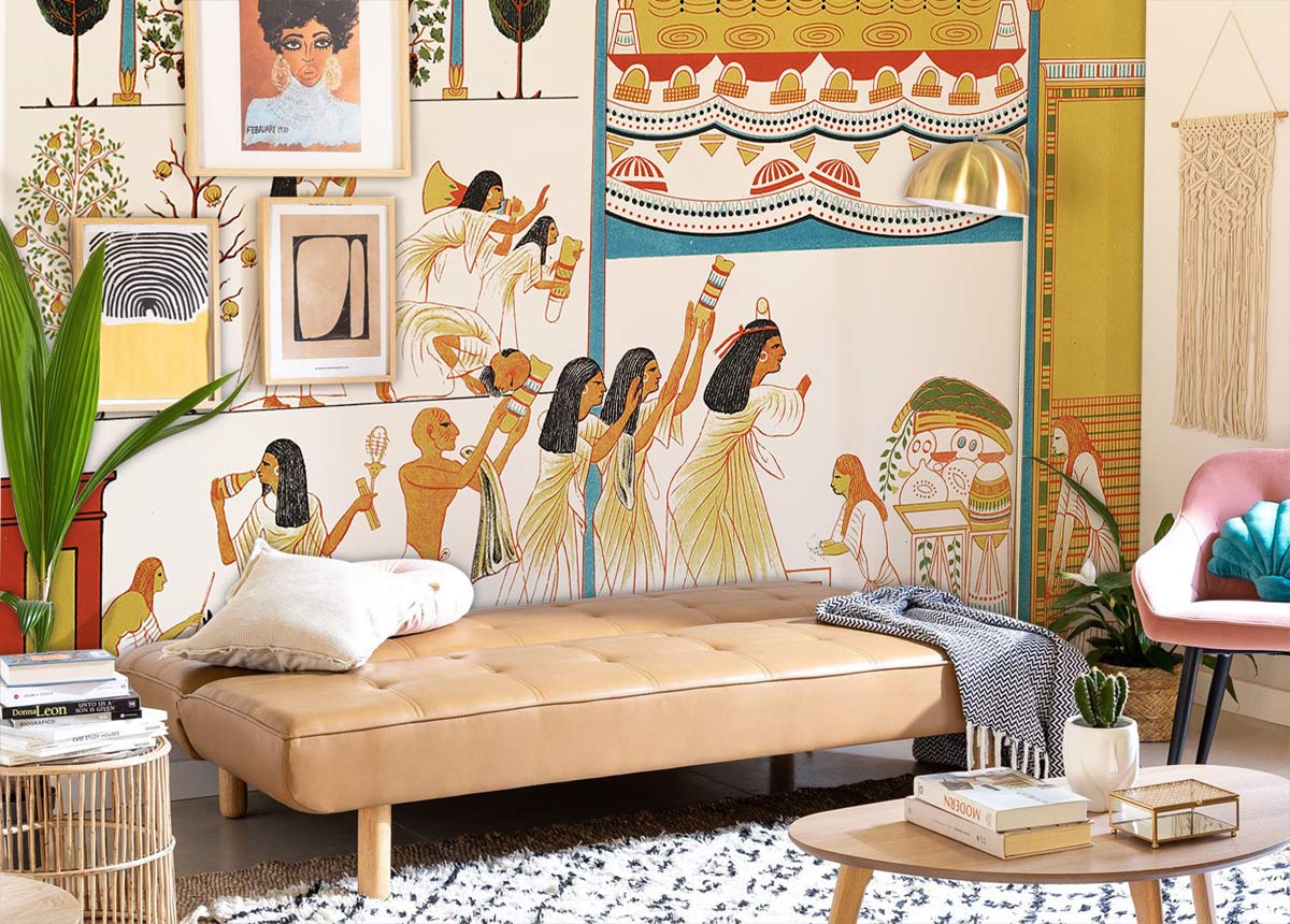 Ancient Egyptian mural wallpaper with colourful design, tan leather sofa, cosy living room decor.