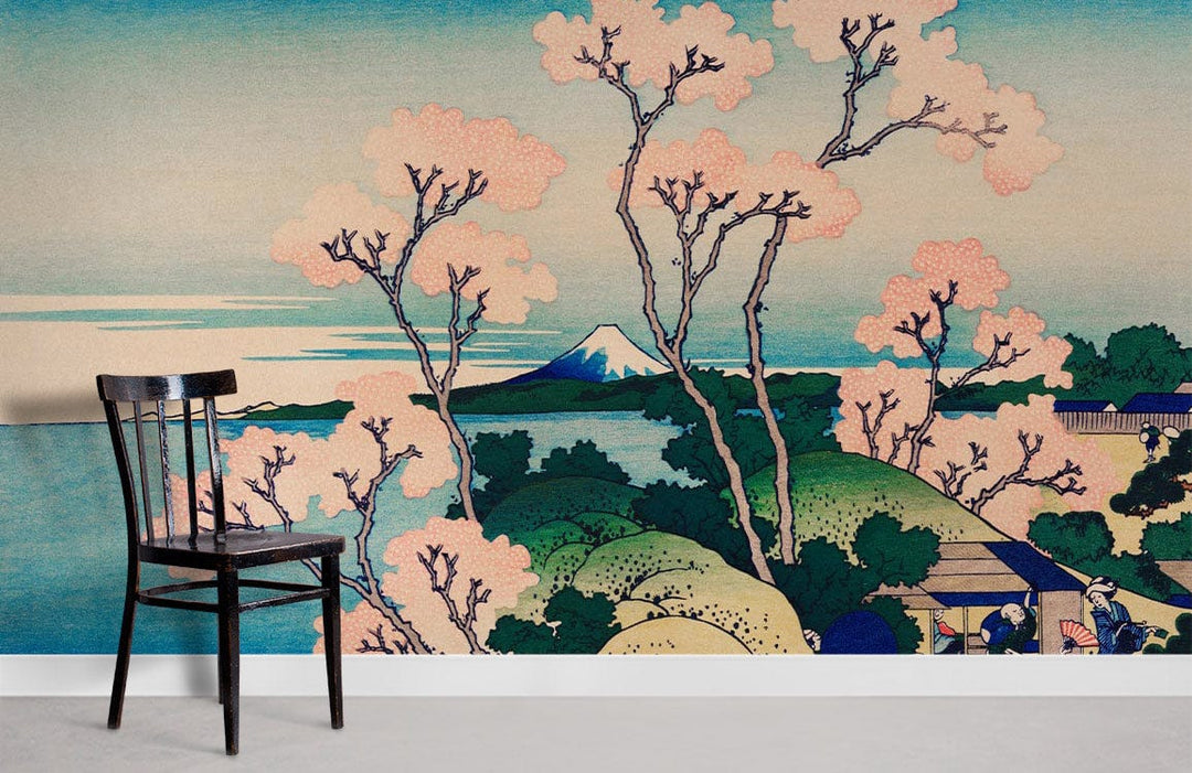 Black chair, serene Japanese landscape mural with sakura blossoms and blue horizon, grey floor, wall art.