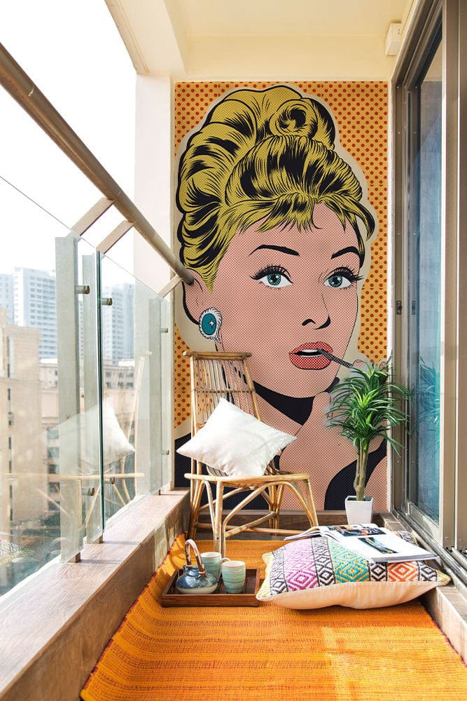 Retro Pop Art Mural Wallpaper on balcony with wicker chair, glass railing, and orange rug.