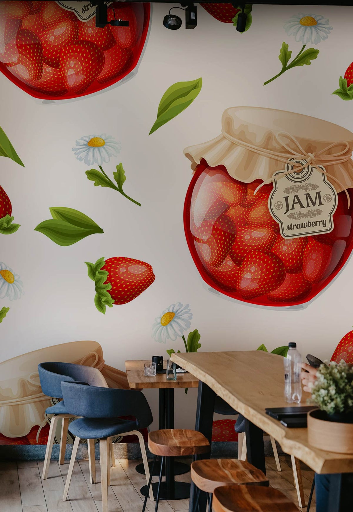 Vintage farmhouse kitchen with Strawberry Jam Pattern Wallpaper; wooden table, blue chairs, light wood flooring.