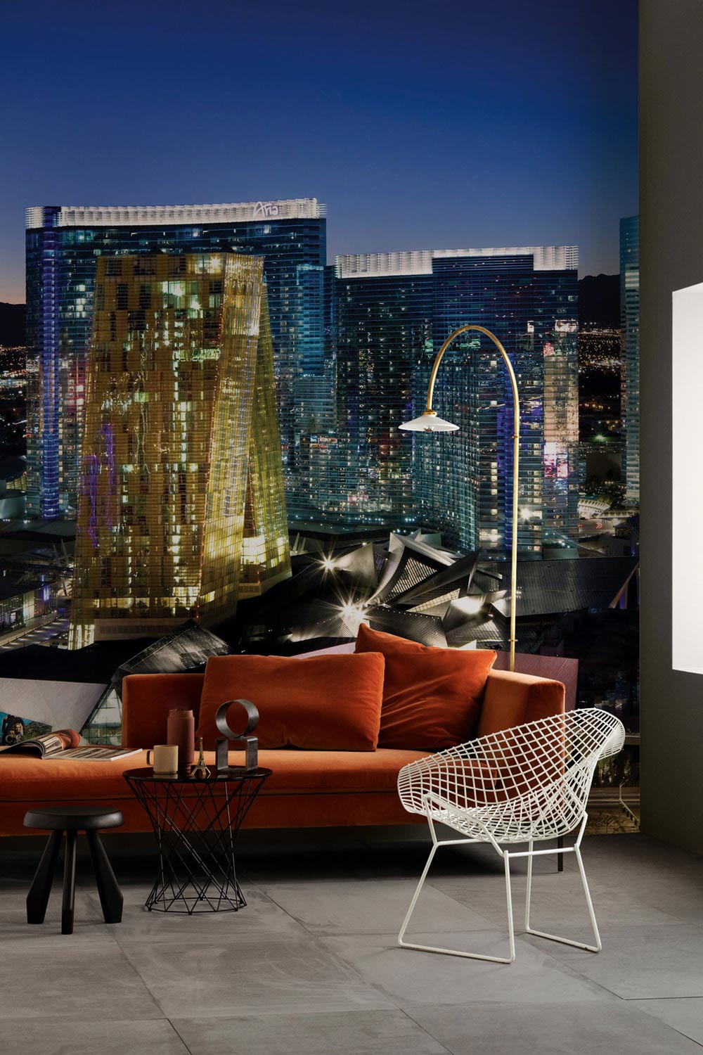 Vibrant Night Cityscape Mural Wallpaper in modern living room with orange sofa and grey flooring.