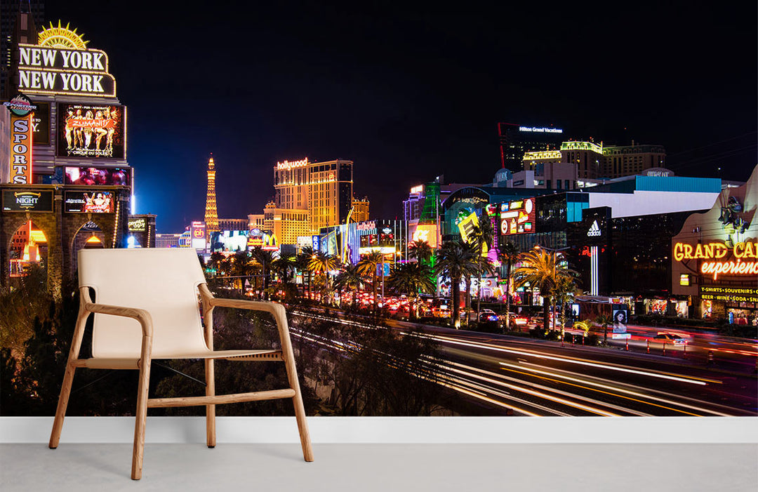 Vibrant Las Vegas mural wallpaper in modern room with beige chair, white skirting board, and grey flooring.