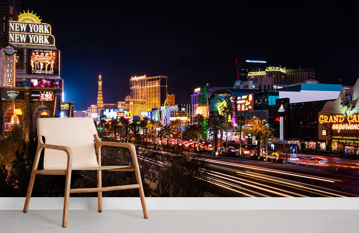 Vibrant Las Vegas mural wallpaper in modern room with beige chair, white skirting board, and grey flooring.