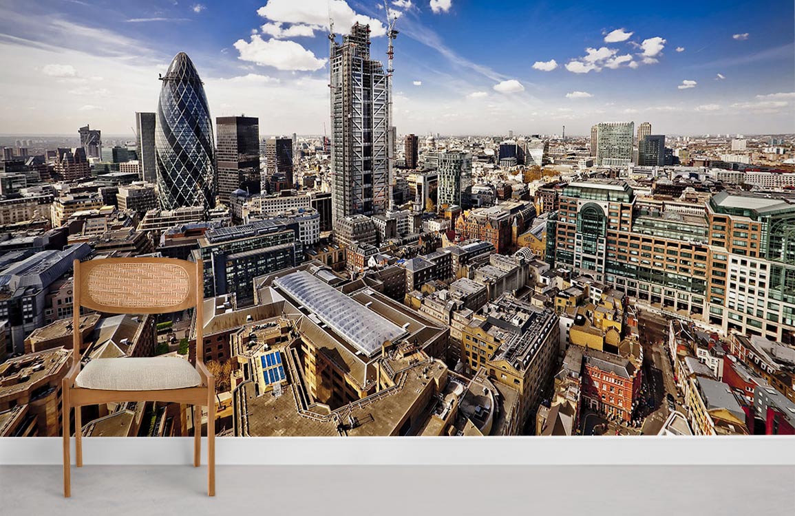 Chair in front of London Skyline Mural Wallpaper, vibrant blue sky, grey flooring. Cityscape view.