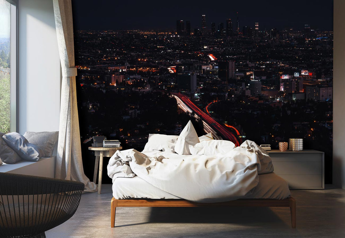 Vibrant Urban Nightscape Skyline Mural on bedroom wall with contemporary bed, neutral flooring, and armchair.