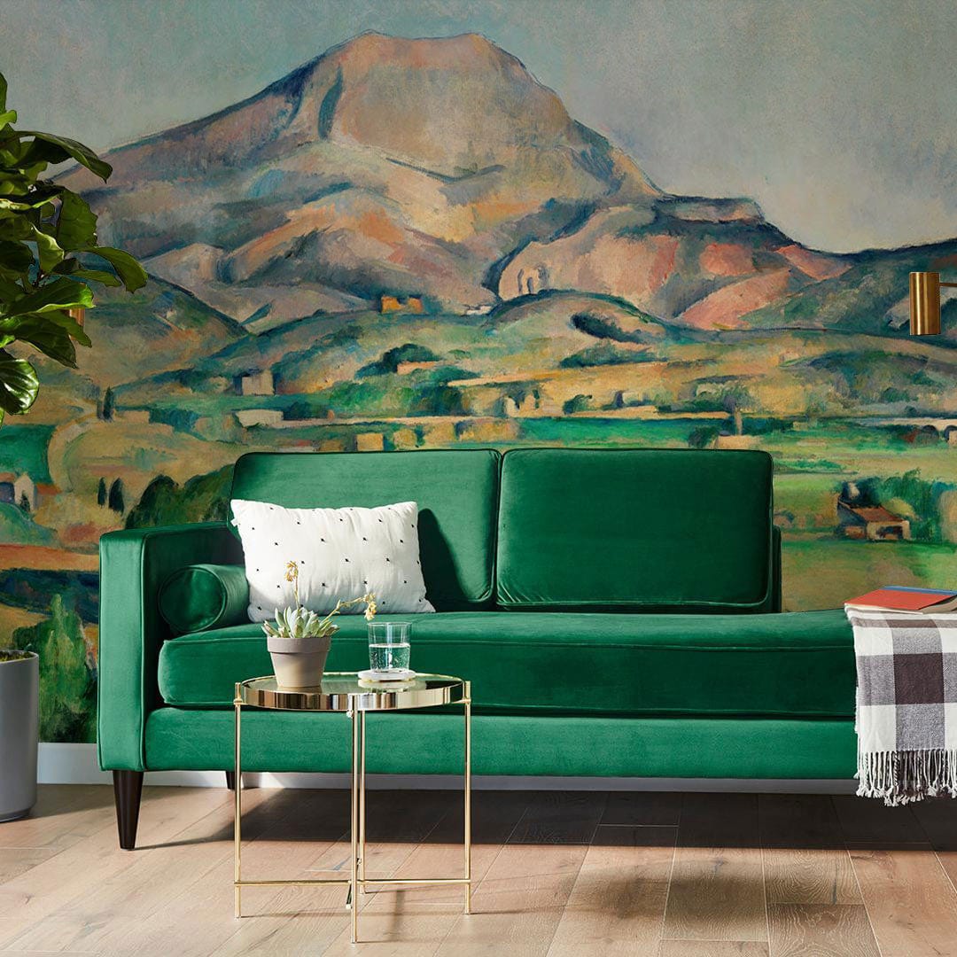 Green velvet sofa, gold side table, Impressionist Landscape Mural Wallpaper: Serene Green Mountain Vista Design.