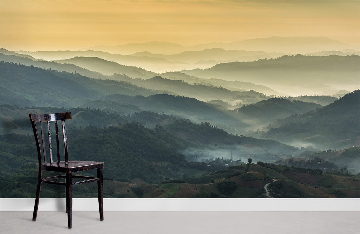 Tranquil Misty Mountains mural wallpaper, earthy tones, wooden chair, grey flooring, scenic room backdrop.