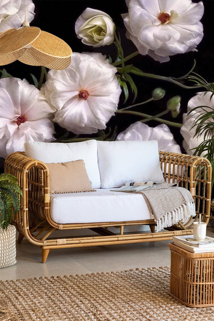 Rattan sofa, cream floral pattern mural wallpaper, neutral rug, rattan table, elegant interior decor.