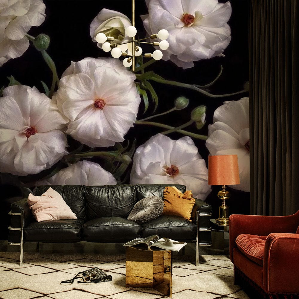 Elegant floral mural wallpaper in living room with black sofa, orange lamp, patterned flooring.