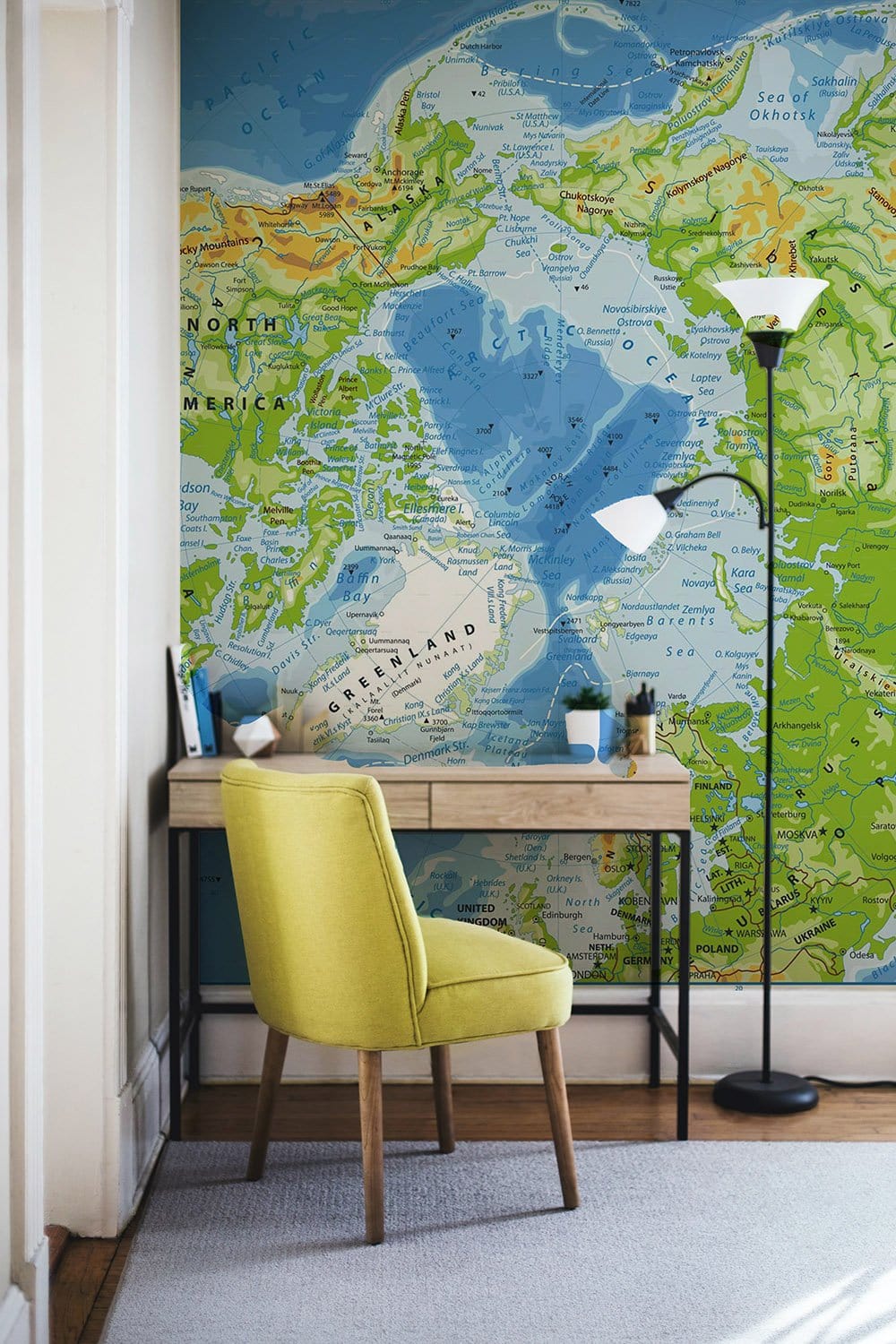 World Explorer's mural wallpaper, map design, neutral room, yellow chair, wooden desk, lamp, rug floor.