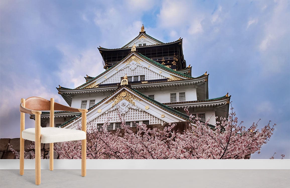 Chair in front of Japanese cherry blossom mural wallpaper featuring castle, light grey floor, serene setting.