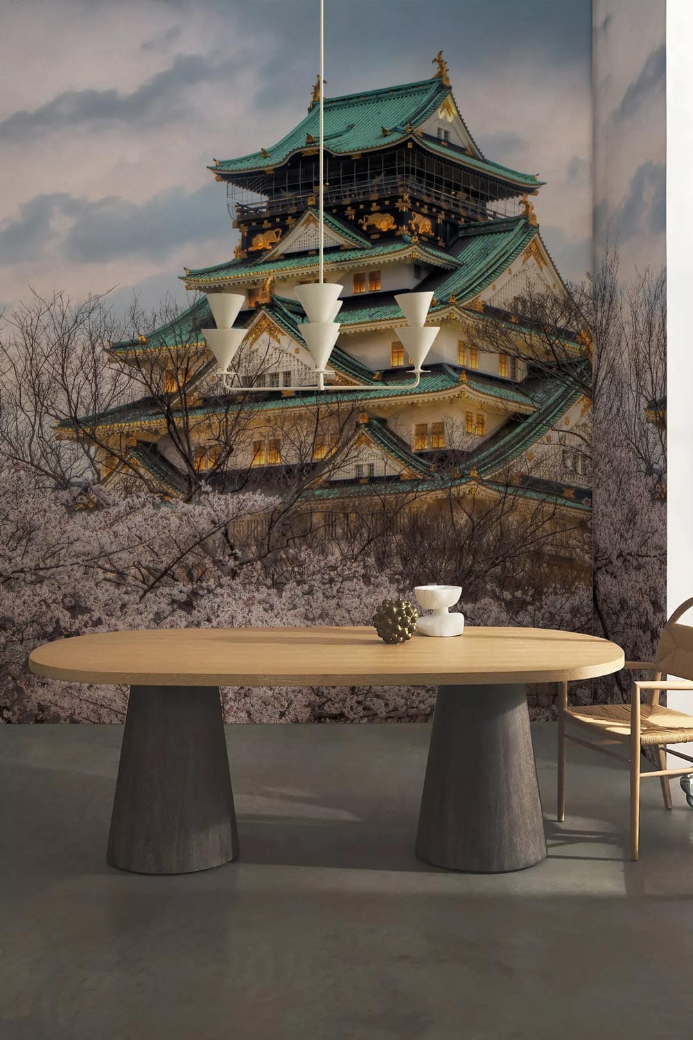 Serene Japanese Castle mural wallpaper art with round wooden table, modern chairs, pendant light, concrete floor.