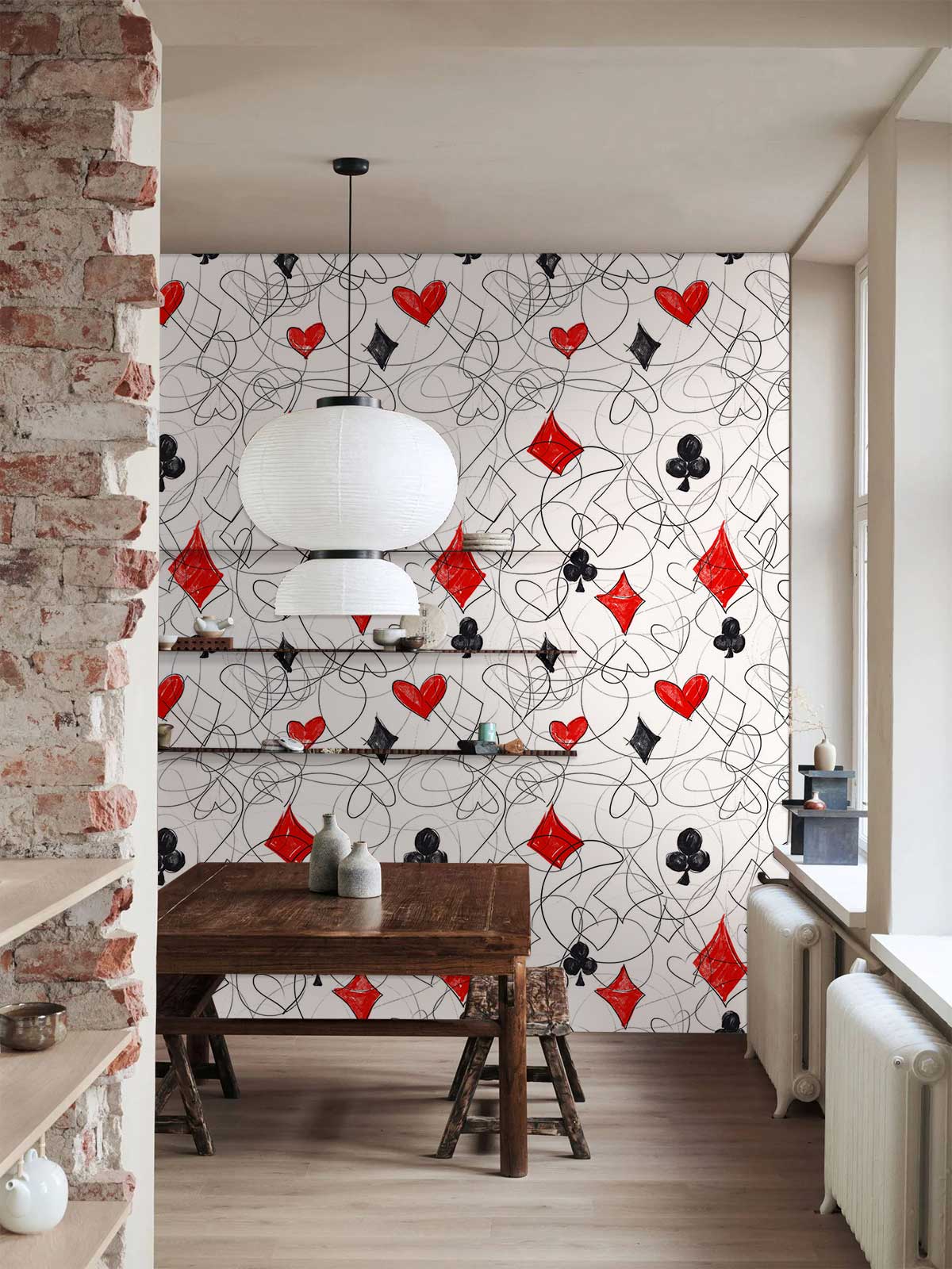 Red and Black Playing Cards Wallpaper in dining room with rustic brick wall and wooden table, modern decor.