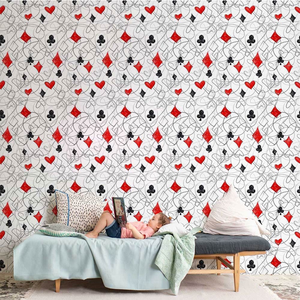 Red and black playing cards wallpaper, light blue sofa, modern gaming decor, living room setting.