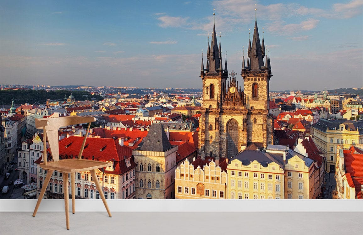 Charming Prague skyline mural wallpaper in warm hues, wooden chair, grey floor, modern interior design.