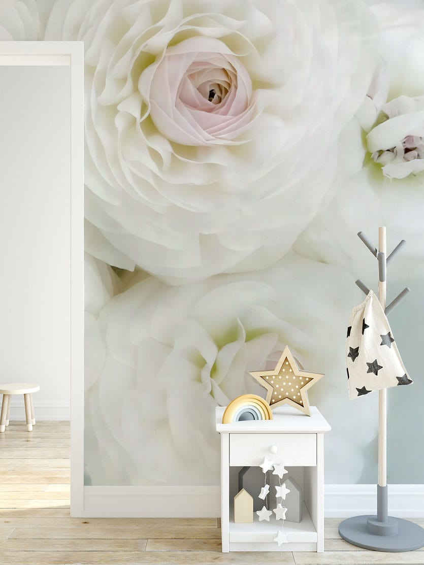 Elegant floral mural wallpaper with pastel accents in children's room, featuring wooden flooring and coat rack.