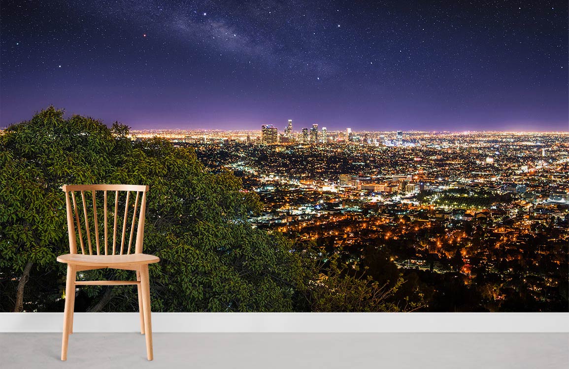 Stunning night cityscape mural wallpaper in living room, featuring urban lights, wooden chair, grey flooring.
