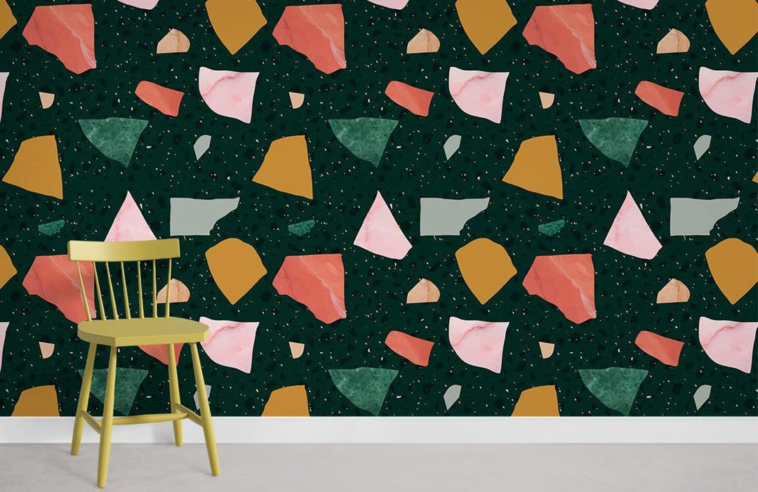 Abstract multicolour geometric terrazzo wallpaper with green chair and light grey flooring in modern room.