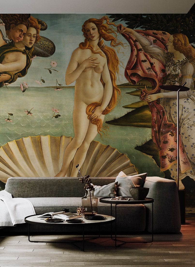Luxurious grey sofa, wood flooring, modern lamp, Botticelli's mural wallpaper creating elegant living room ambiance.