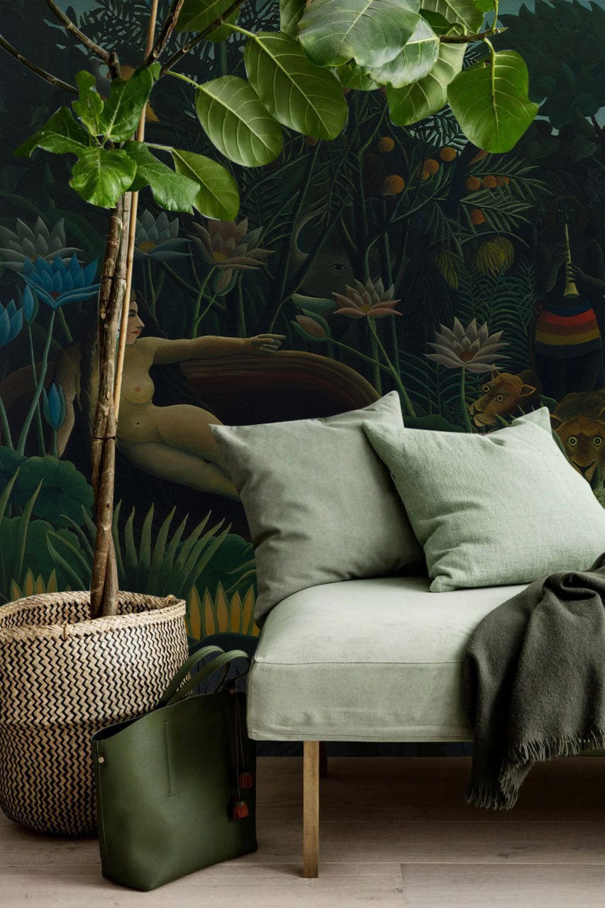Exotic Jungle Mural: Lush Nature Scene, green sofa, woven plant basket, wooden flooring, serene setting.