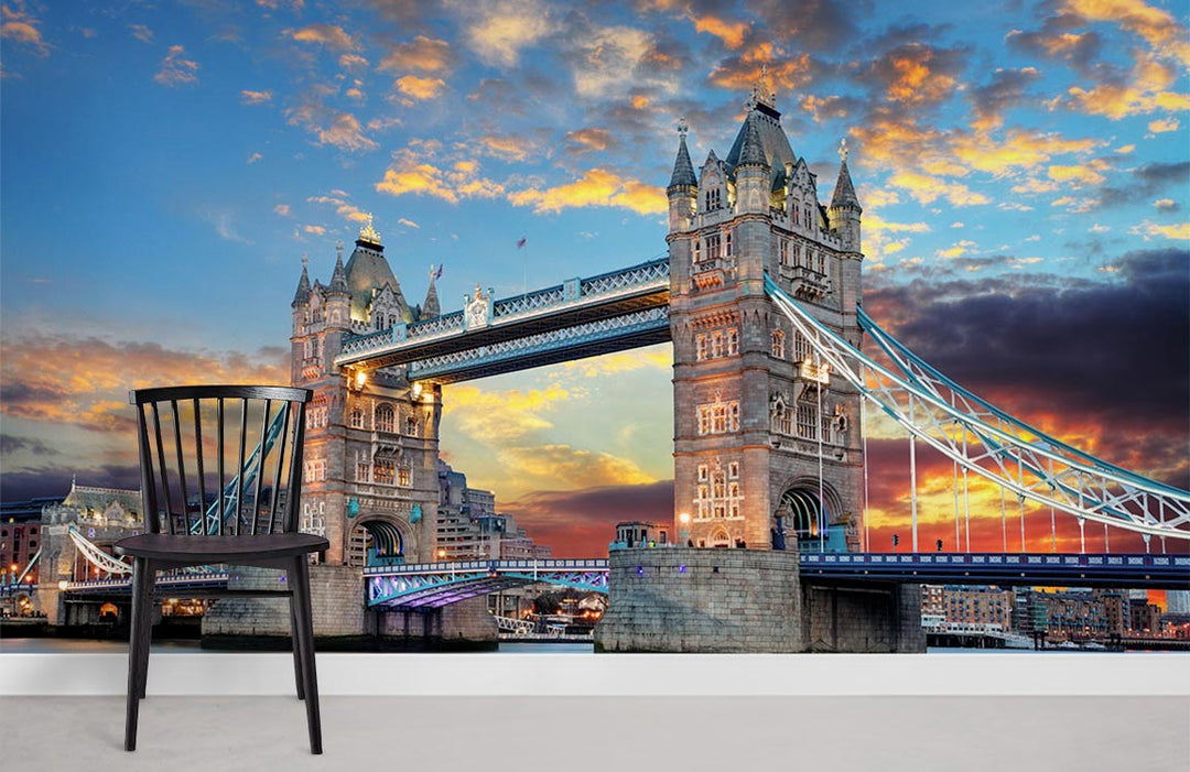 Chair by vibrant London Tower Bridge sunset mural wallpaper in minimalist room with white floor.