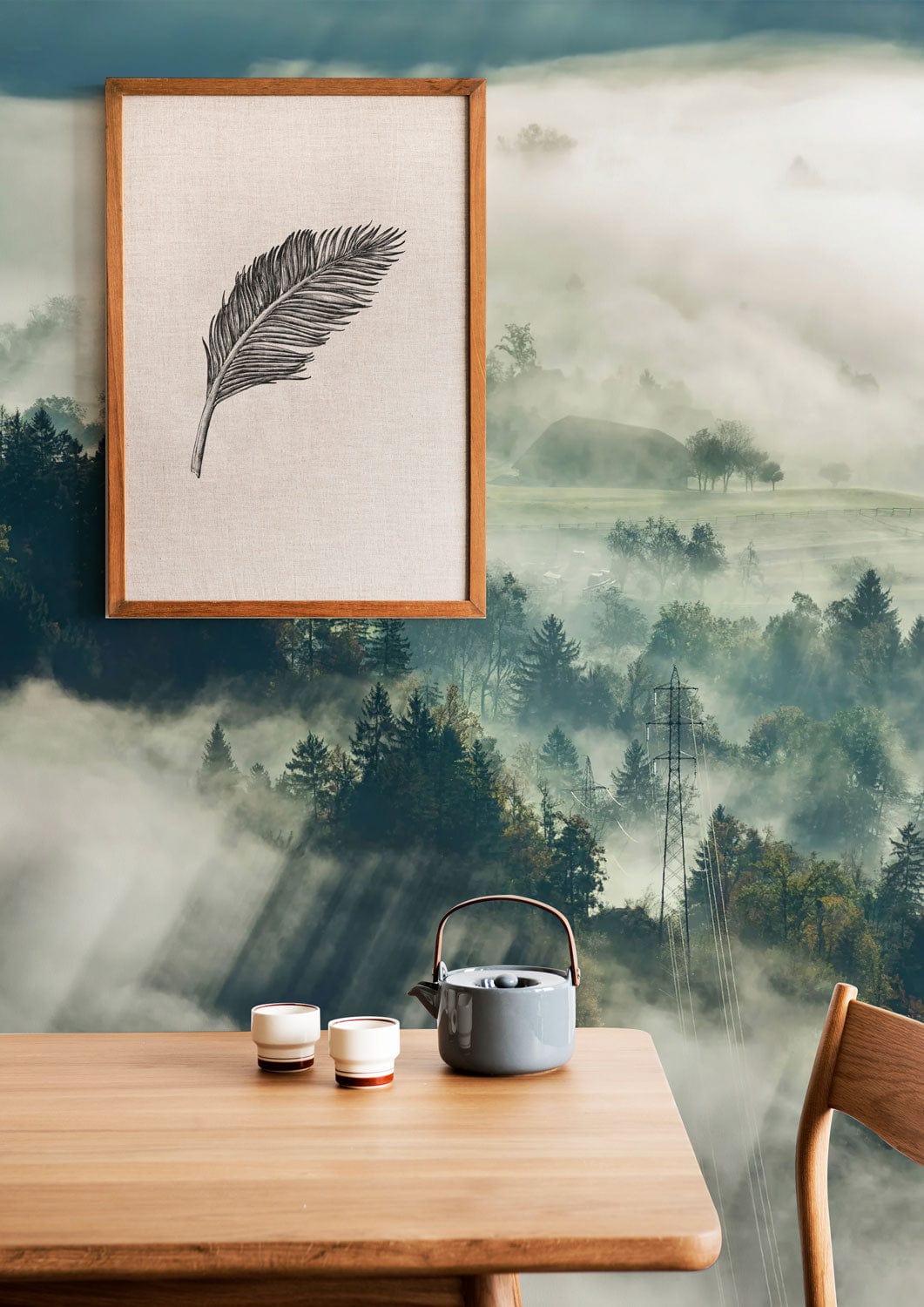 Mist-covered forest mural in earthy tones, wooden furniture, framed art; serene, natural room setting.