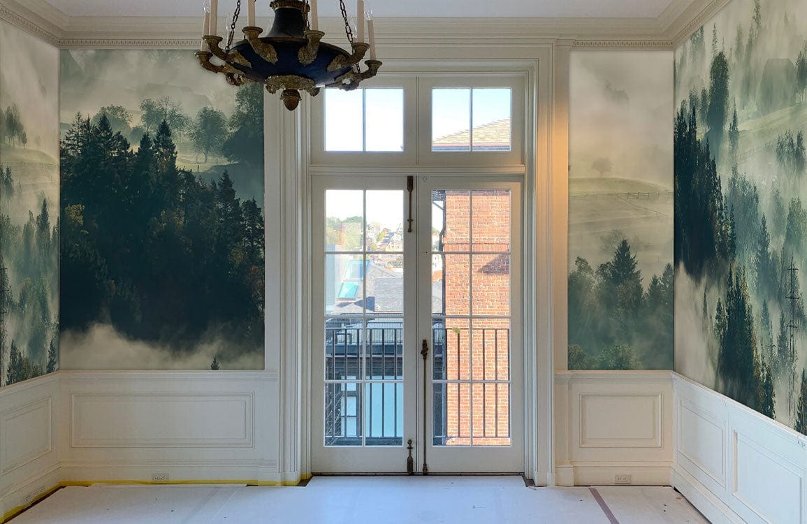 Mist-covered forest mural wallpaper in earthy tones in elegant living room with classic chandelier.