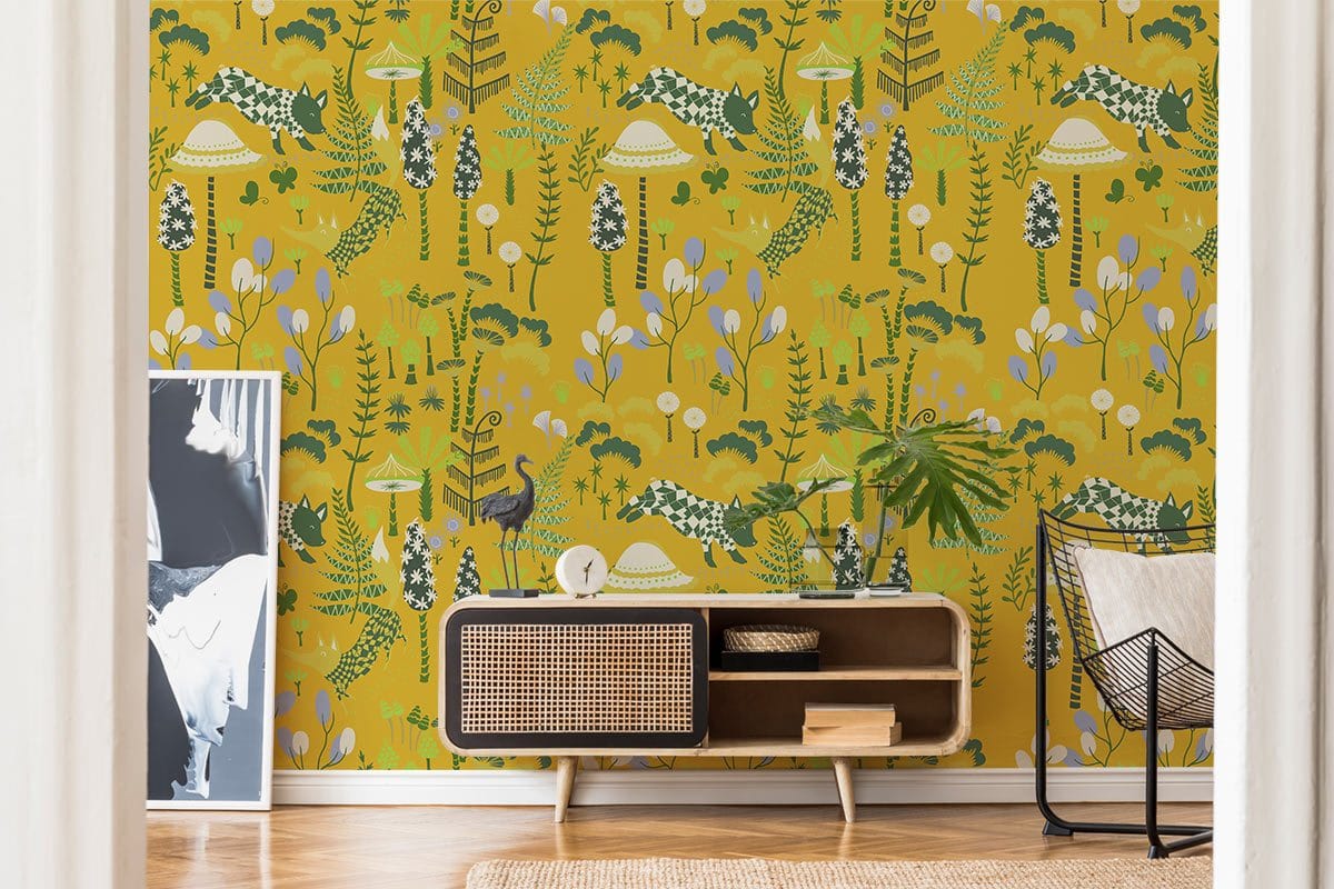 Vibrant mustard safari wallpaper with green animals, modern sideboard, wooden flooring, stylish chair.