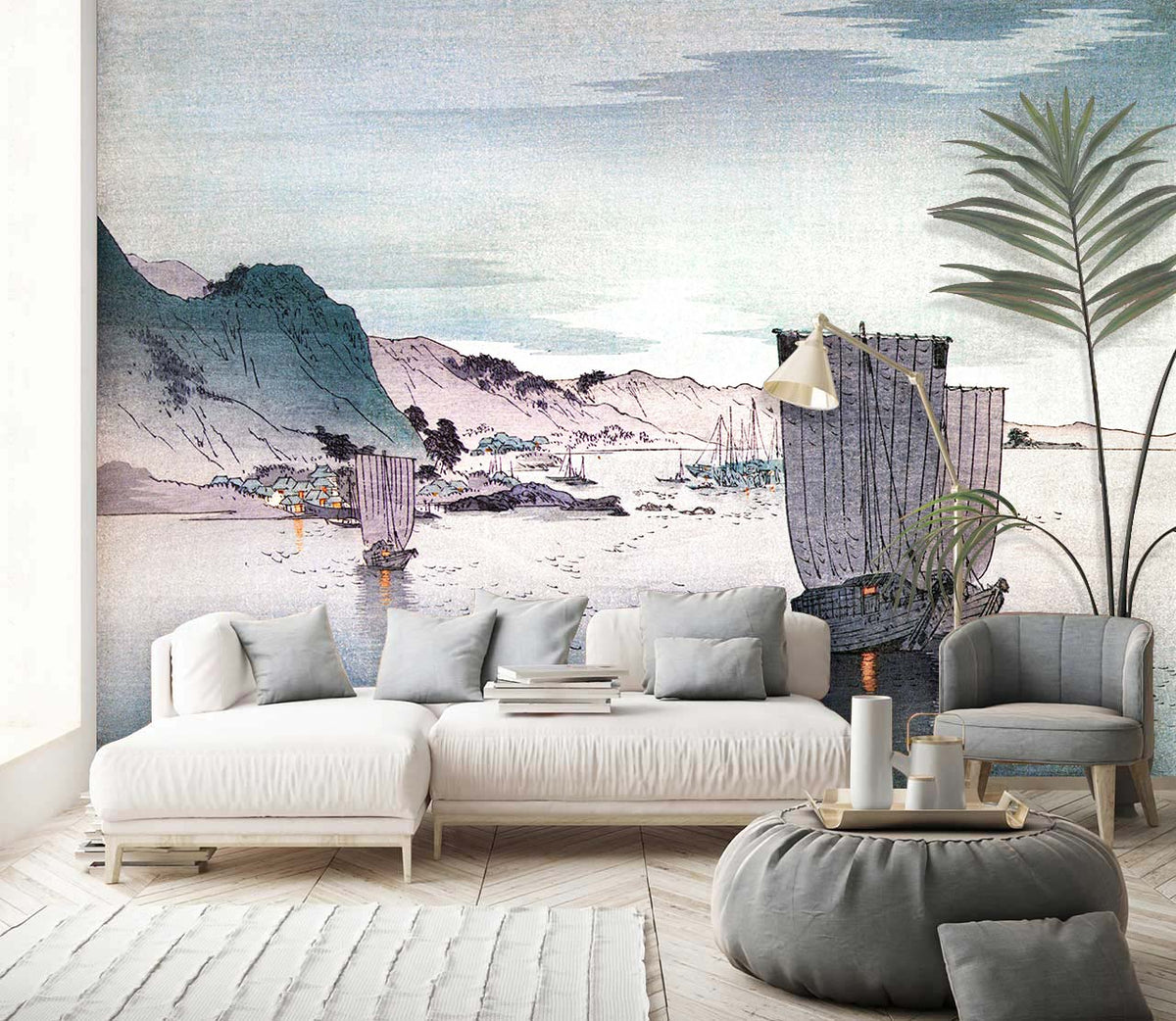 Tranquil seascape mural wallpaper, vintage boats; white sofa, armchair, grey pouffe, wood flooring, living room.