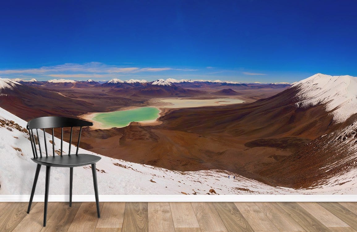 Majestic Alpine Landscape Mural Wallpaper, rich blue earth tones, black chair, wooden flooring, modern style.