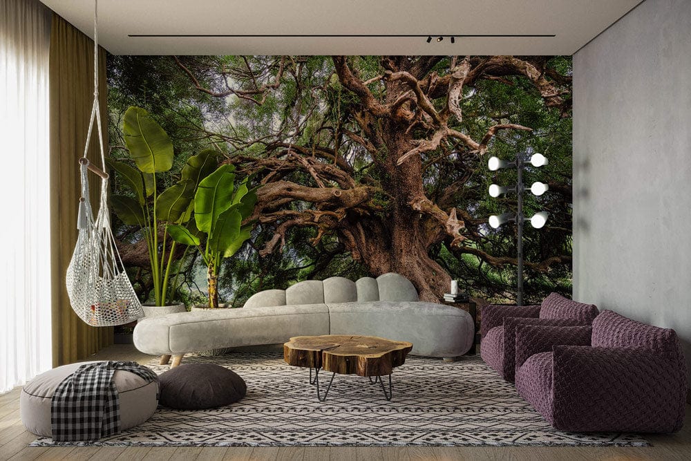 Majestic Ancient Tree Mural with grey sofa, hanging chair; earthy tones wallpaper, rustic wooden table.