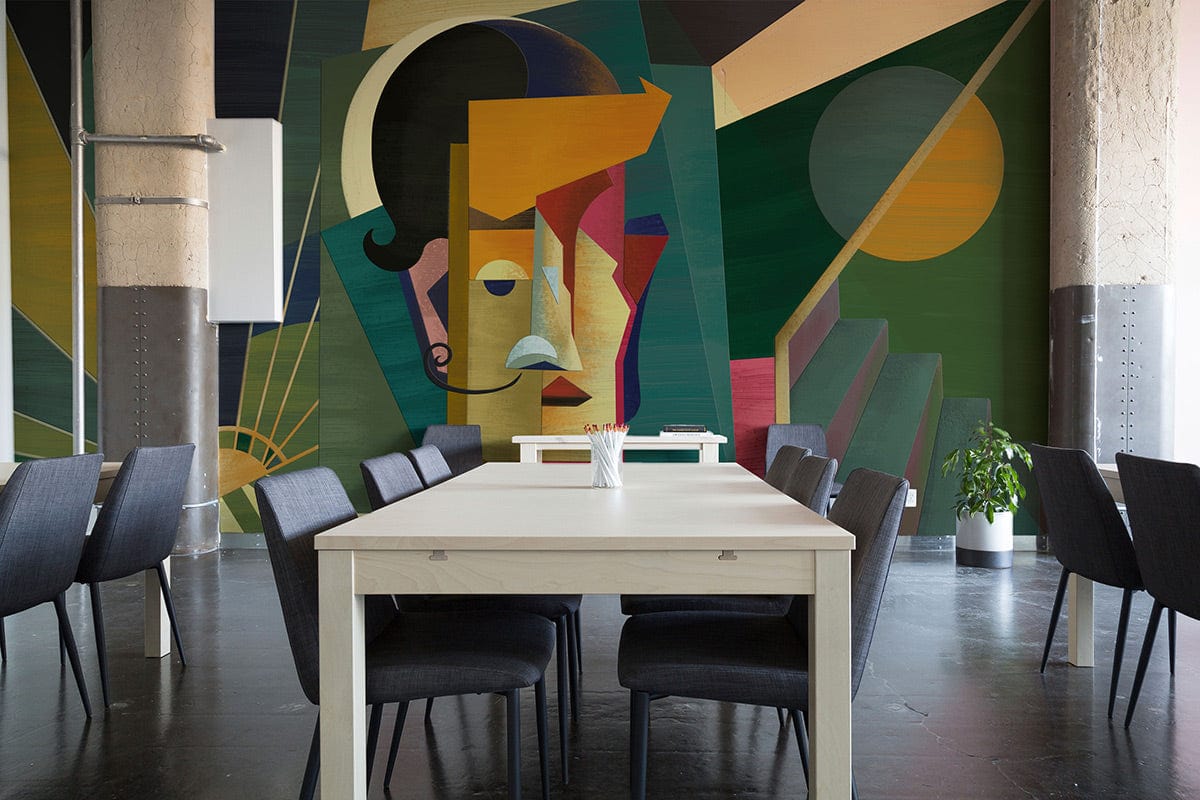 Geometric Abstract Cubism mural in green, orange; grey chairs, white table, industrial-style room setting.