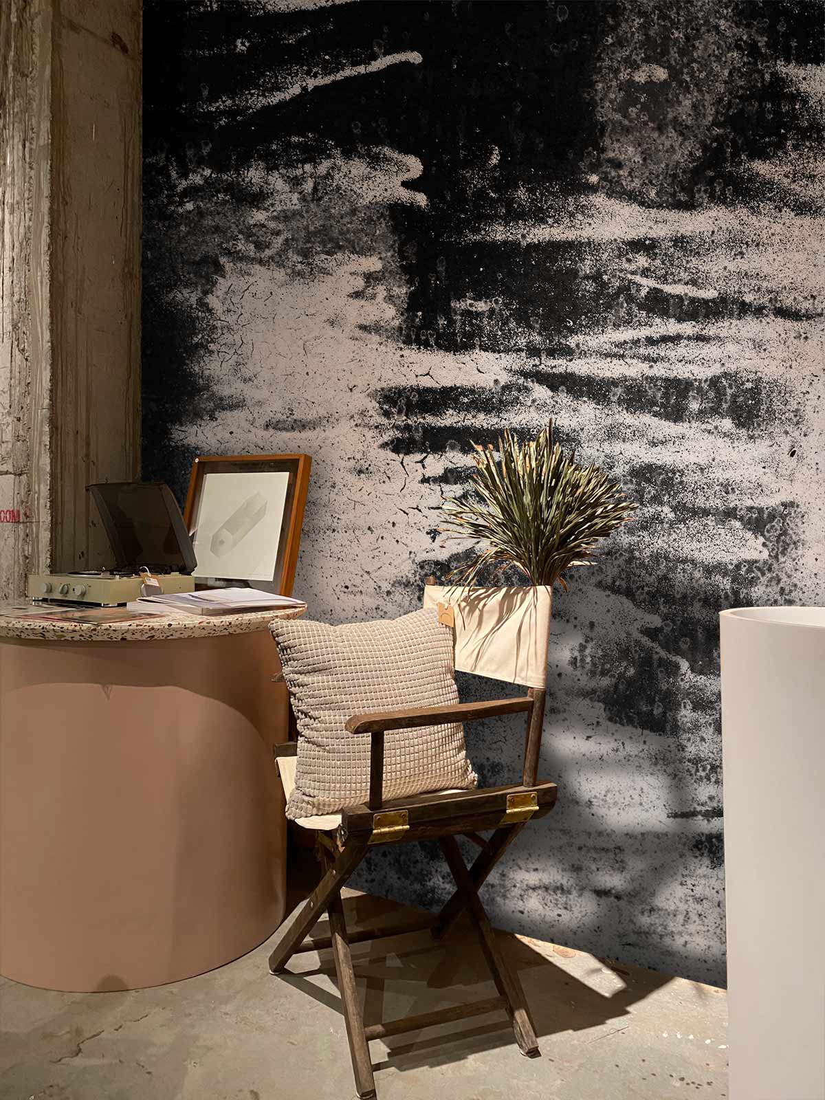 Modern artistic grey tones wallpaper in office; featuring wooden chair, curved desk, minimal decor.